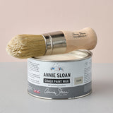 A tin of Annie Sloan Clear Chalk Paint™ Wax paired with a natural bristle waxing brush, perfect for protecting and finishing painted furniture with a smooth, professional finish.