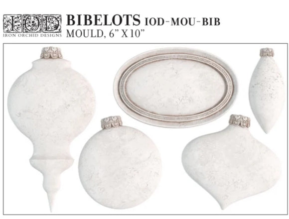 Full product image of the IOD Bibelots Mould, featuring a variety of vintage-inspired ornament shapes and an oval plaque design, with measurements of 6