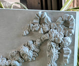 Decorative application of the Bows IOD Décor Mould combined with floral motifs, showcasing intricate bow designs and dimensional textures, ideal for sophisticated furniture or wall art.