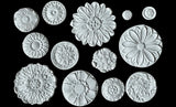 A close-up view of intricate decorative rosettes created using the IOD Rosettes 6 x 10 Décor Mould. Perfect for adding unique embellishments to furniture and crafts.