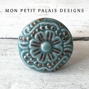 Seafoam Green Embossed Ceramic Knob with raised floral detailing, gold highlights, and a vintage-inspired glaze for furniture and cabinetry.