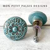 Pair of Seafoam Green Embossed Ceramic Knobs with intricate raised floral detailing and antique gold highlights, perfect for coastal and vintage furniture.